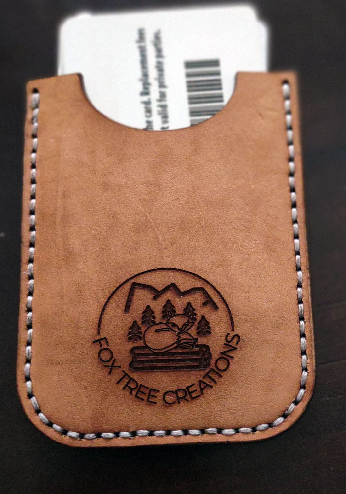 Fox Tree Creations minimalist card wallet in tan leather with an embossed logo and stitched edges