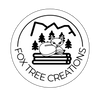 Fox Tree Creations logo with a fox lying on logs in front of trees and mountains custom laser-engraved gifts fee