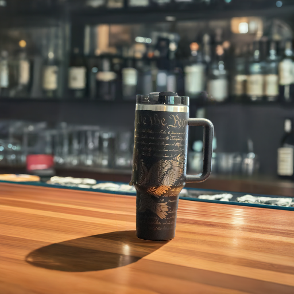Custom engraved Freedom 40oz tumbler by Fox Tree Creations featuring a sleek black design for stylish hydration