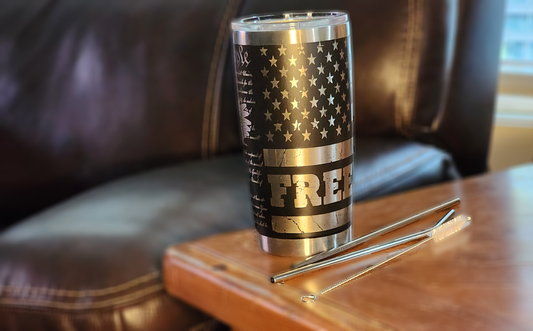 Custom engraved freedom 20oz tumbler featuring a black and silver American flag design with straws