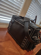 Custom leather messenger bag by Fox Tree Creations with distinctive stitching and metallic accents