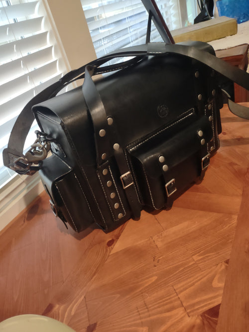 Custom leather messenger bag from Fox Tree Creations with multiple compartments and a sturdy strap
