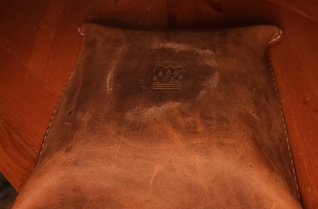 Fox Tree Creations full grain leather valet tray with embossed logo on brown leather surface