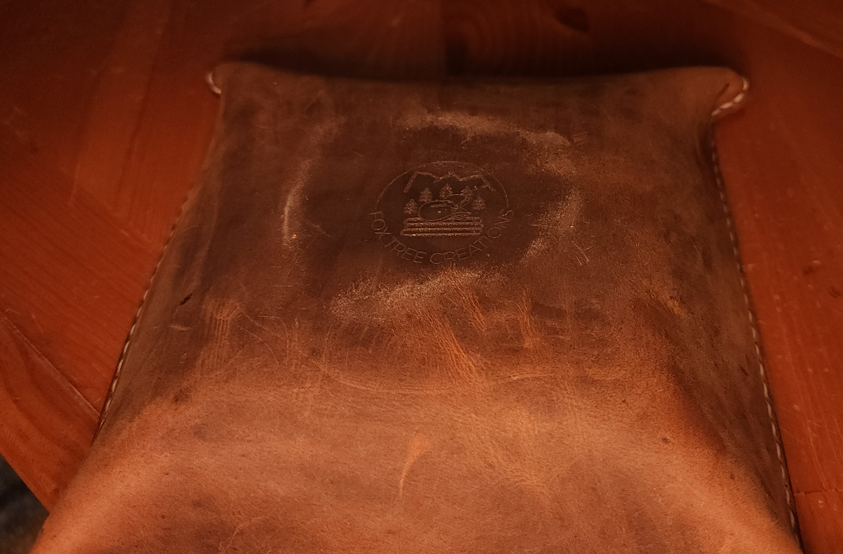 Fox Tree Creations full grain leather valet tray with embossed logo on brown leather surface