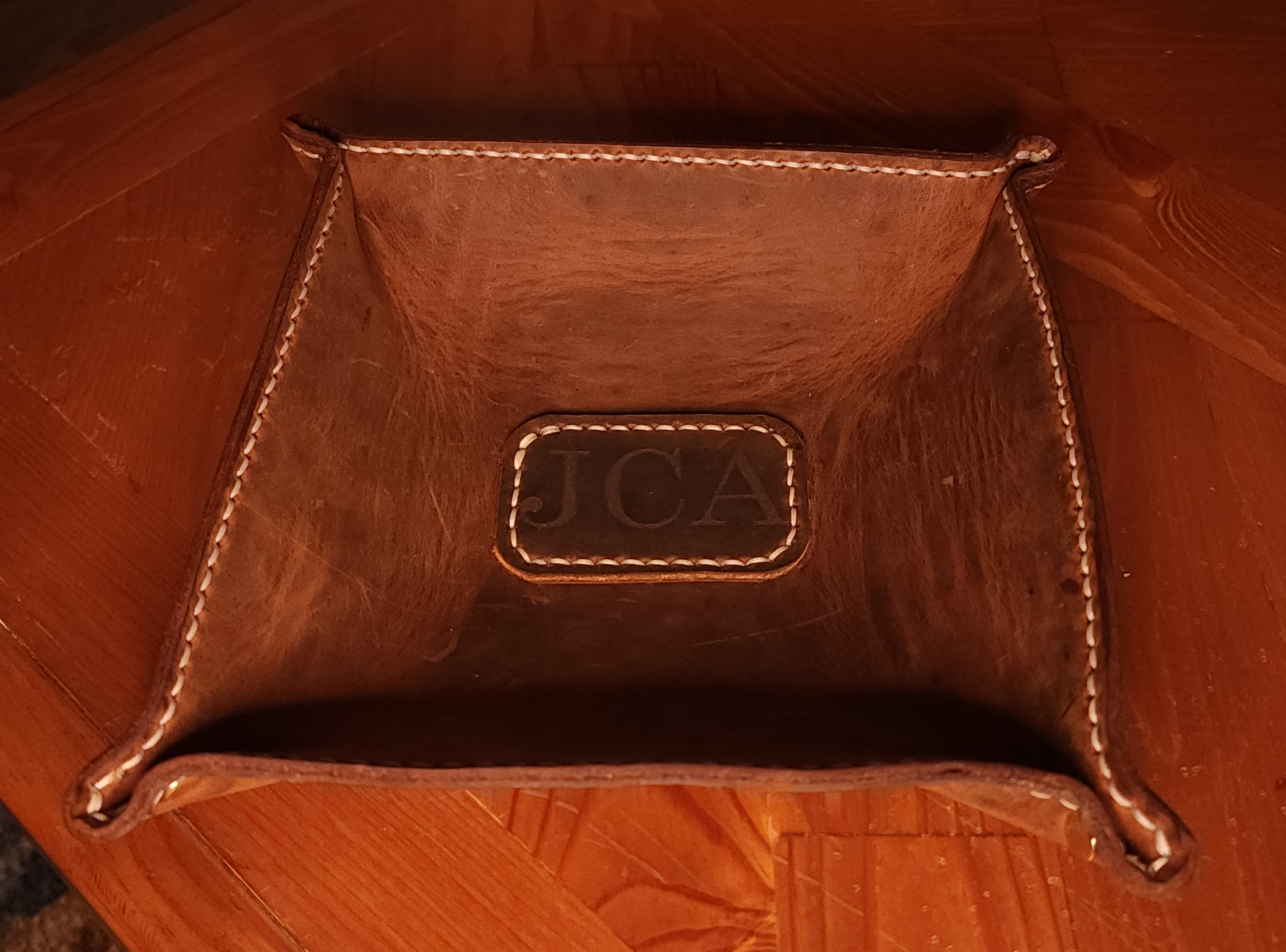 Fox Tree Creations full grain leather valet tray with stitched edges on wooden surface