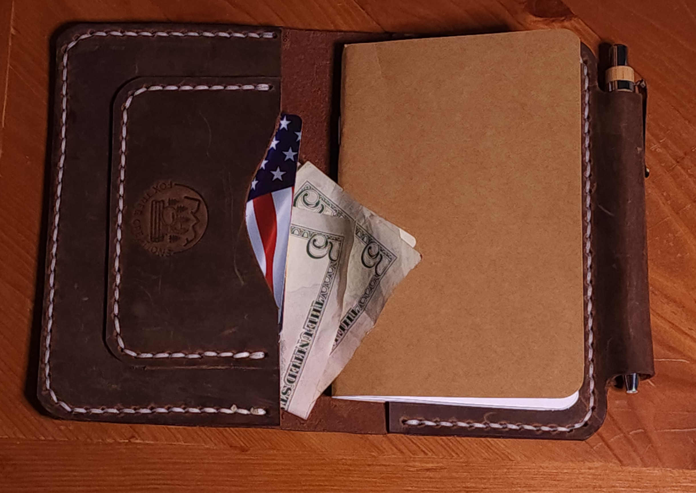 Fox Tree Creations full grain leather field notes cover with card slots and pen holder showing a notebook and cash inside