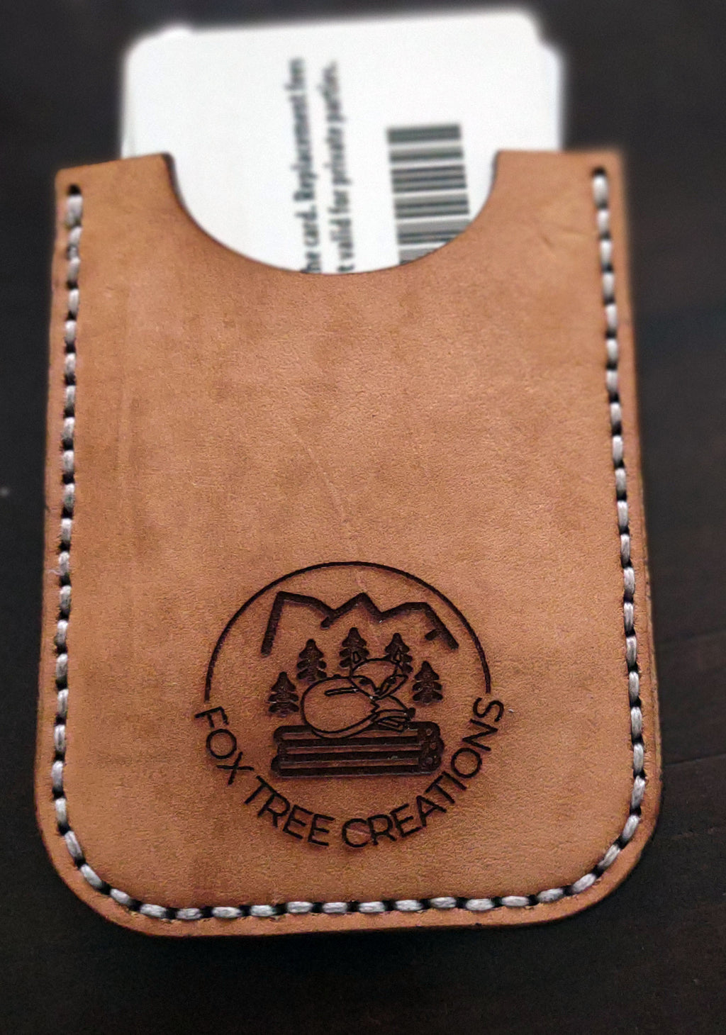 Fox Tree Creations minimalist card wallet in tan leather with an embossed logo and stitched edges