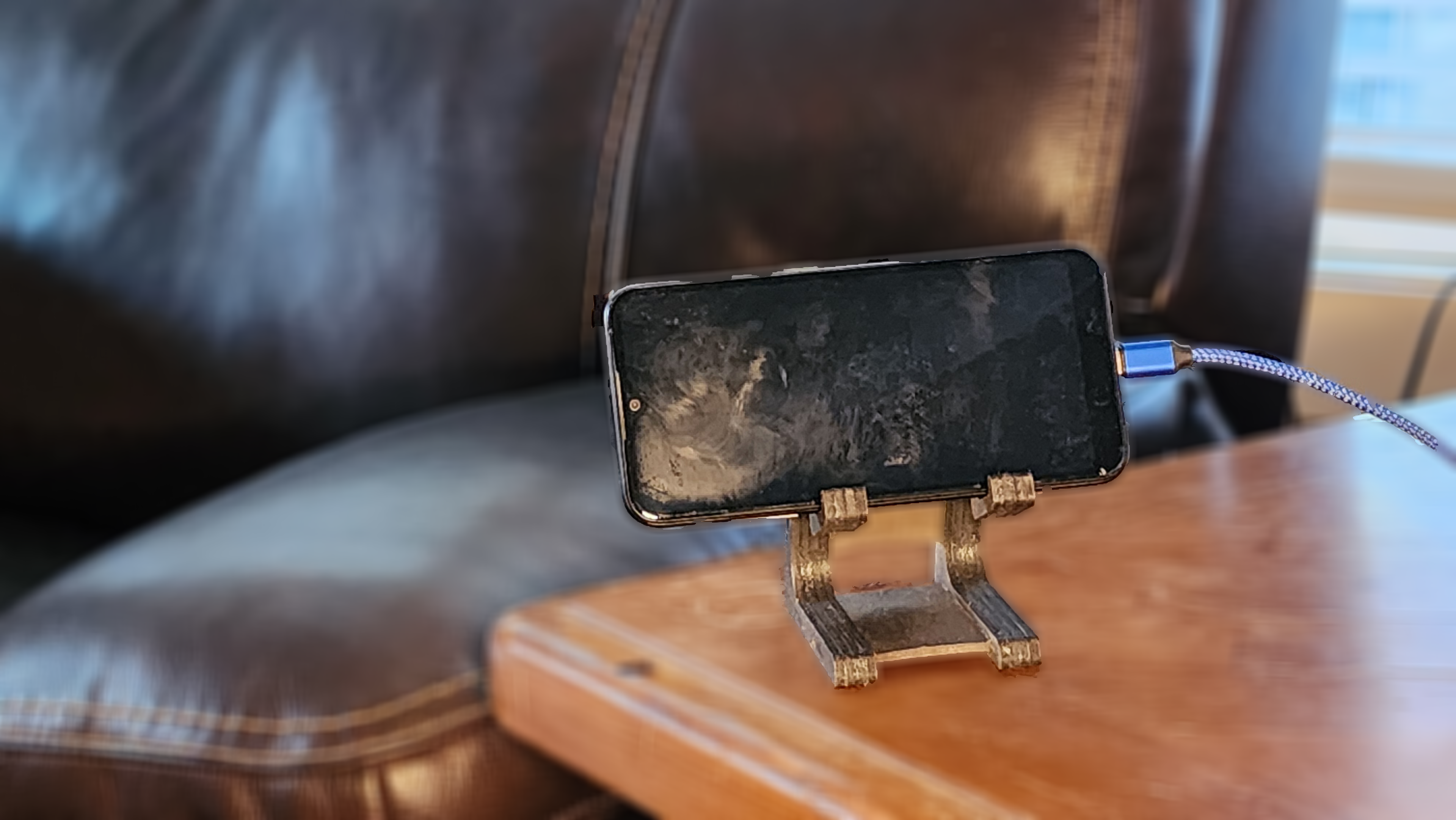 Fox Tree Creations personalized device stand supporting a smartphone on a wooden table