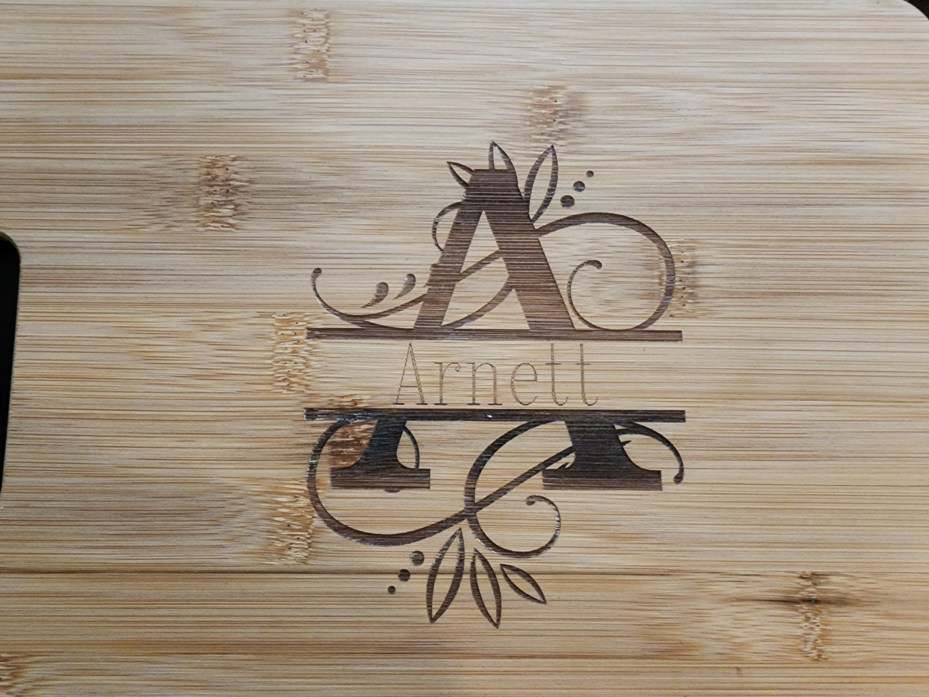 Personalized monogram cutting board with intricate design featuring the letter A and the name Arnett