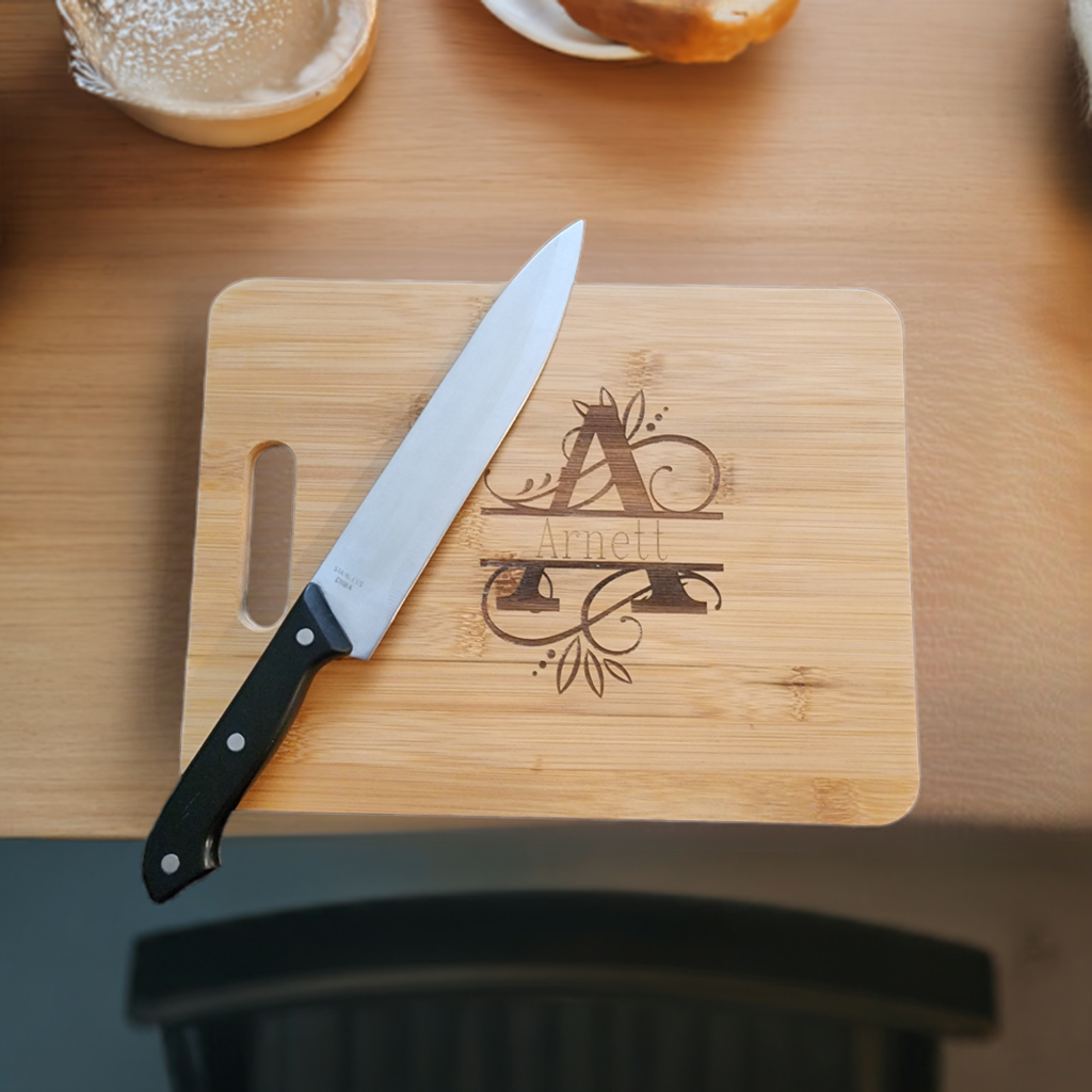 Personalized monogram cutting board from Fox Tree Creations with elegant design and knife on a wooden table