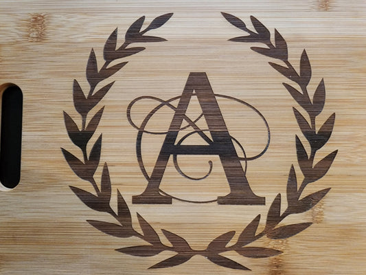 Personalized monogram cutting board with elegant A design surrounded by a decorative laurel wreath