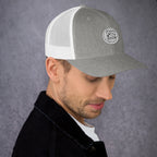 Gray and white unique gift trucker cap featuring a stylish patch design on the front