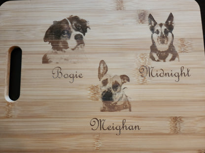 Unique picture cutting board featuring custom pet engravings of dogs with names Bogie, Midnight, and Meighan